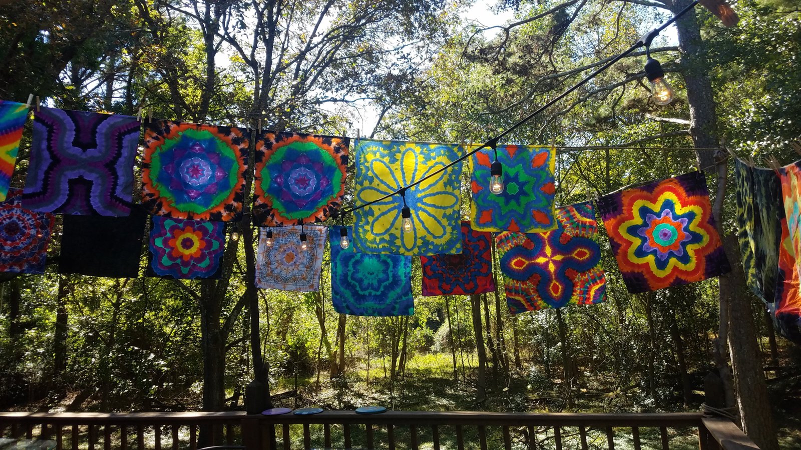 Colorful tie-dye bandanas drying outdoors on a line